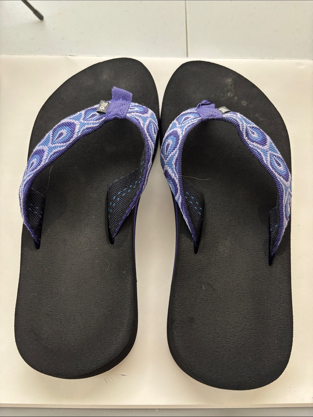 Teva Women’s Black Flip Flops with Purple Patterned Straps